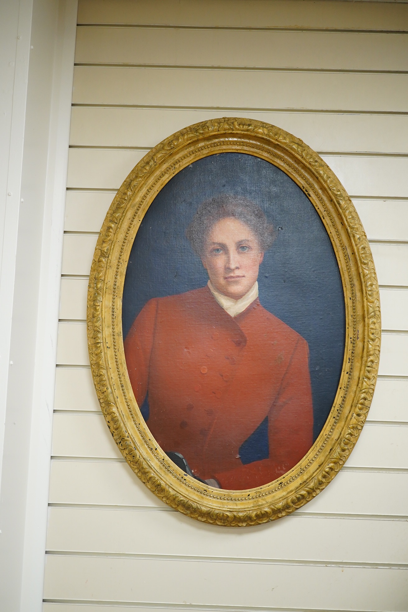 English school, oval oil on board, study of a lady wearing a riding habit, unsigned, 71 x 49cm. Condition - fair